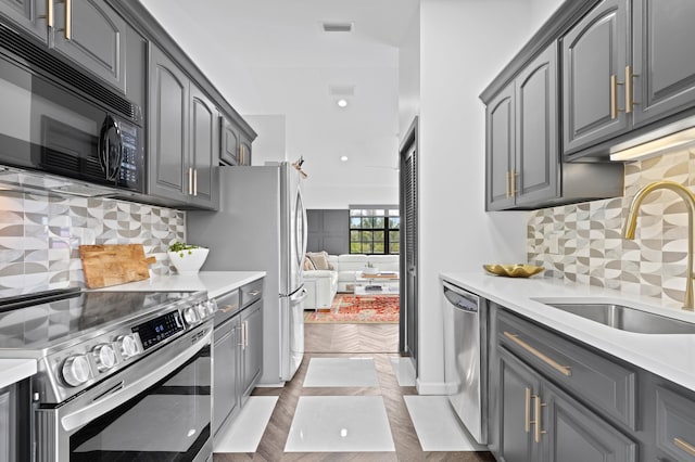 3510 Embassy Dr, West Palm Beach, FL 33401 - kitchen featuring visible vents, gray cabinets, a sink, stainless steel appliances, and light countertops