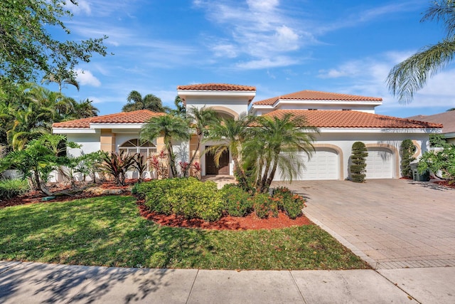 6131 NW 30th Ave, Boca Raton, FL 33496 - mediterranean / spanish-style home featuring a tiled roof, decorative driveway, an attached garage, and stucco siding