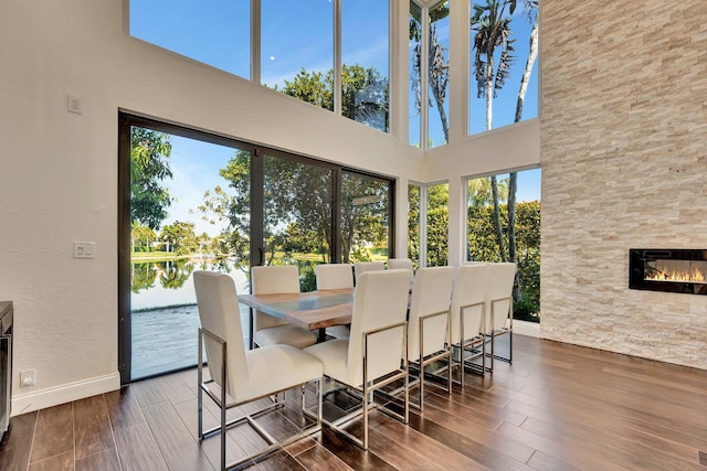 6131 NW 30th Ave, Boca Raton, FL 33496 - dining room with baseboards, a water view, wood finished floors, and a fireplace