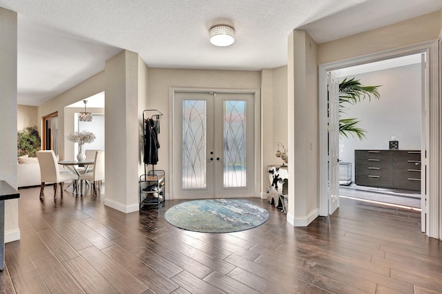 6131 NW 30th Ave, Boca Raton, FL 33496 - entryway with french doors, baseboards, a textured ceiling, and wood finished floors