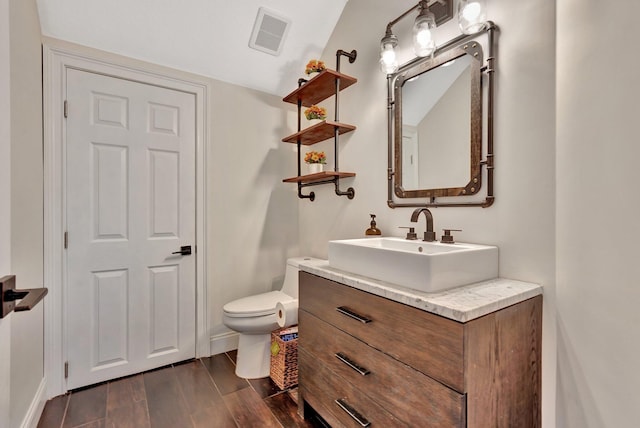 6131 NW 30th Ave, Boca Raton, FL 33496 - half bath with visible vents, toilet, wood finished floors, baseboards, and vanity