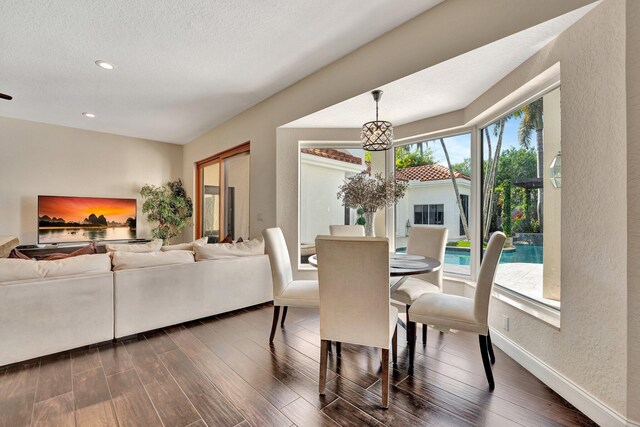 6131 NW 30th Ave, Boca Raton, FL 33496 - dining area featuring dark wood finished floors, recessed lighting, a textured wall, a notable chandelier, and a textured ceiling