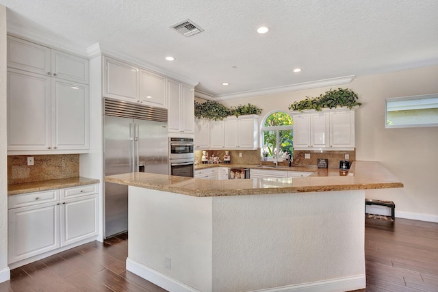 6131 NW 30th Ave, Boca Raton, FL 33496 - kitchen with dark wood finished floors, visible vents, white cabinets, and appliances with stainless steel finishes