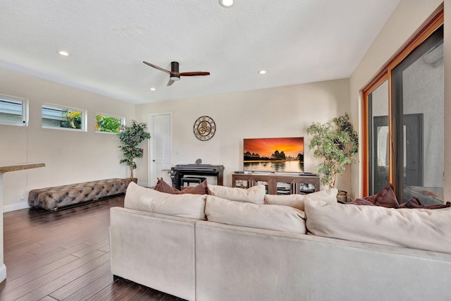 6131 NW 30th Ave, Boca Raton, FL 33496 - living room featuring ceiling fan, recessed lighting, a wood stove, dark wood-style floors, and a textured ceiling