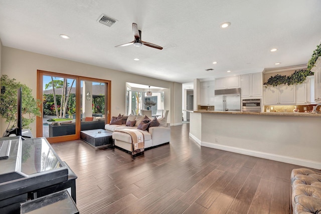 6131 NW 30th Ave, Boca Raton, FL 33496 - living area with visible vents, baseboards, wood finished floors, and a ceiling fan