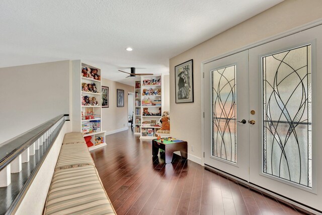 6131 NW 30th Ave, Boca Raton, FL 33496 - playroom featuring french doors, a textured ceiling, baseboards, and wood finished floors