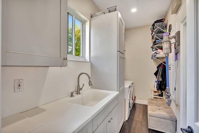 6131 NW 30th Ave, Boca Raton, FL 33496 - washroom with recessed lighting, cabinet space, dark wood-style flooring, a sink, and washing machine and dryer