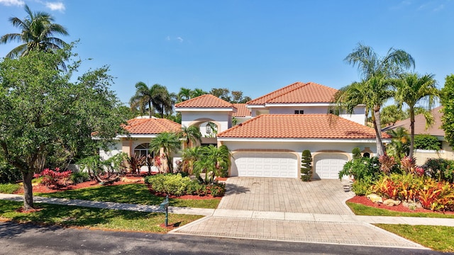 6131 NW 30th Ave, Boca Raton, FL 33496 - mediterranean / spanish home with decorative driveway, stucco siding, an attached garage, and a tiled roof