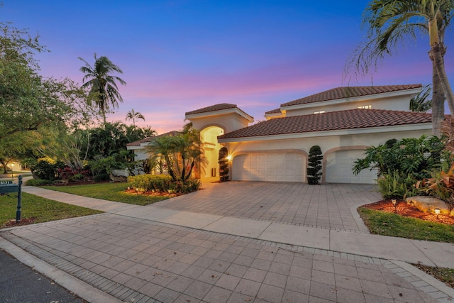 6131 NW 30th Ave, Boca Raton, FL 33496 - mediterranean / spanish-style house with stucco siding, a tiled roof, an attached garage, and decorative driveway