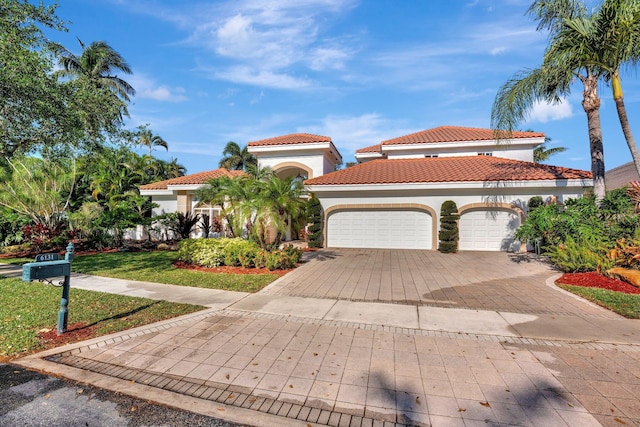 6131 NW 30th Ave, Boca Raton, FL 33496 - mediterranean / spanish house with a front lawn, a tile roof, stucco siding, decorative driveway, and an attached garage