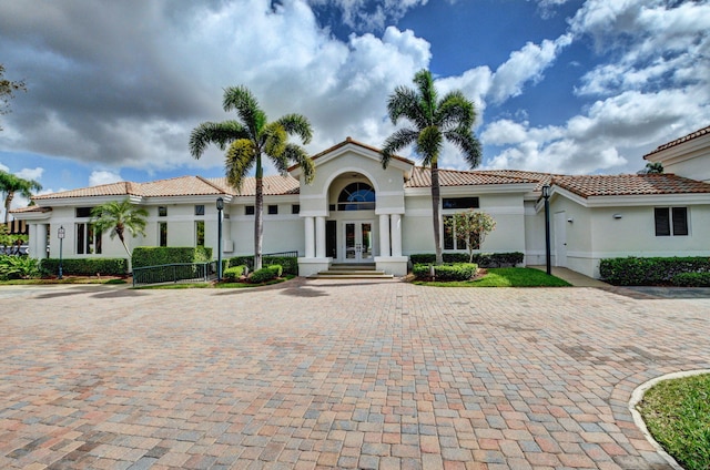 6131 NW 30th Ave, Boca Raton, FL 33496 - mediterranean / spanish-style house with a tiled roof, french doors, driveway, and stucco siding