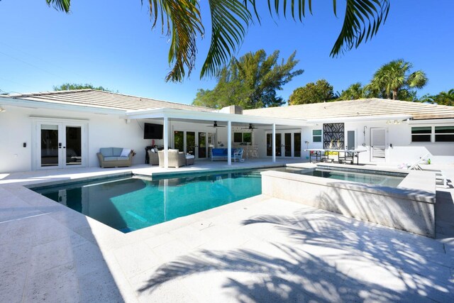 11753 Landing Pl, Palm Beach Gardens, FL 33408 - swimming pool with french doors, an in-ground hot tub, ceiling fan, and outdoor lounge area