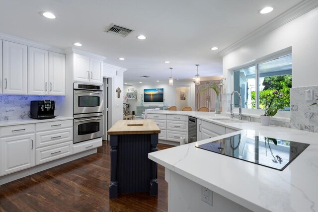 11753 Landing Pl, Palm Beach Gardens, FL 33408 - kitchen featuring a sink, double oven, black electric stovetop, a peninsula, and recessed lighting