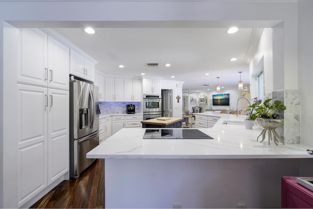 11753 Landing Pl, Palm Beach Gardens, FL 33408 - kitchen with appliances with stainless steel finishes, a sink, a peninsula, white cabinets, and light stone countertops