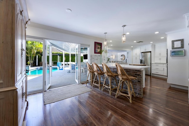 11753 Landing Pl, Palm Beach Gardens, FL 33408 - dining area featuring ornamental molding, dark wood-style flooring, and recessed lighting