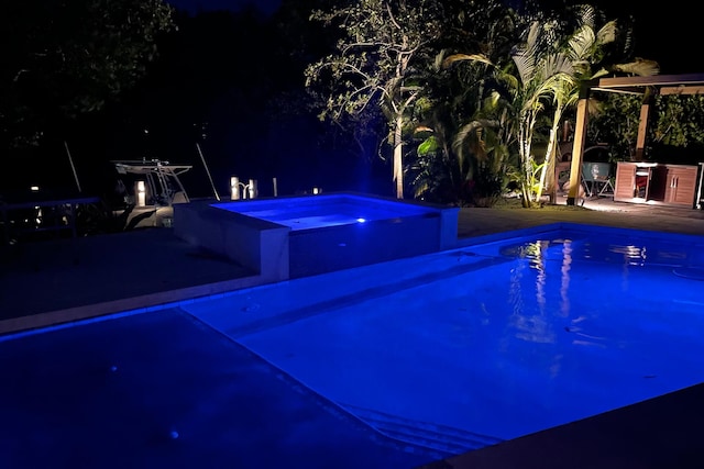 11753 Landing Pl, Palm Beach Gardens, FL 33408 - pool at twilight featuring a patio and a pool with connected hot tub