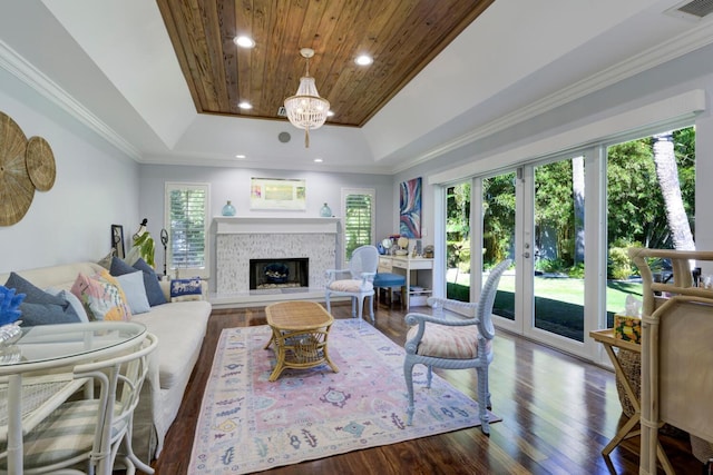 11753 Landing Pl, Palm Beach Gardens, FL 33408 - living area with a raised ceiling, wood finished floors, a glass covered fireplace, recessed lighting, and a chandelier
