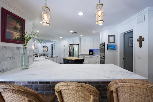 11753 Landing Pl, Palm Beach Gardens, FL 33408 - kitchen with stainless steel appliances, tasteful backsplash, light stone countertops, white cabinetry, and recessed lighting