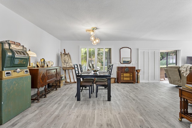 334 NW 42nd St, Boca Raton, FL 33431 - dining area with a chandelier, a textured ceiling, and wood finished floors