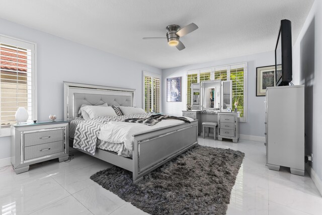 334 NW 42nd St, Boca Raton, FL 33431 - bedroom with multiple windows, a ceiling fan, baseboards, and marble finish floor