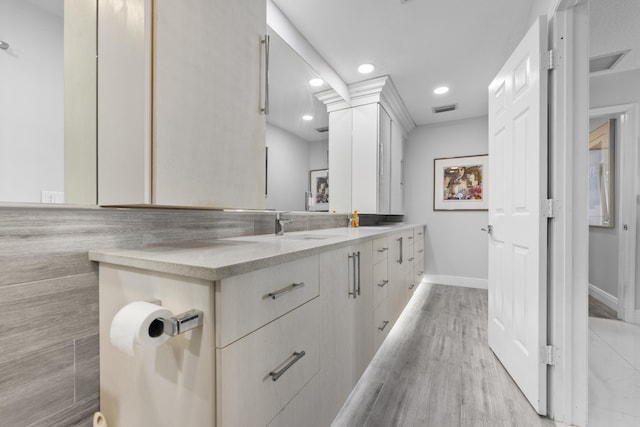 334 NW 42nd St, Boca Raton, FL 33431 - full bath featuring wood finished floors, visible vents, double vanity, recessed lighting, and a sink