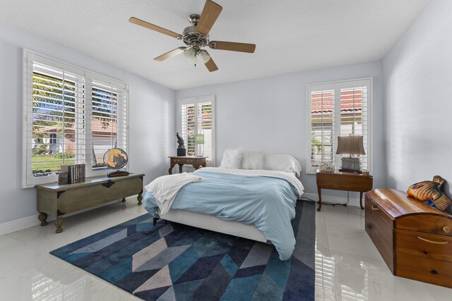 334 NW 42nd St, Boca Raton, FL 33431 - bedroom featuring baseboards, multiple windows, marble finish floor, and ceiling fan