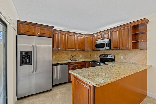 9919 NW 6th Ct, Plantation, FL 33324 - kitchen featuring light stone countertops, decorative backsplash, a peninsula, brown cabinetry, and appliances with stainless steel finishes