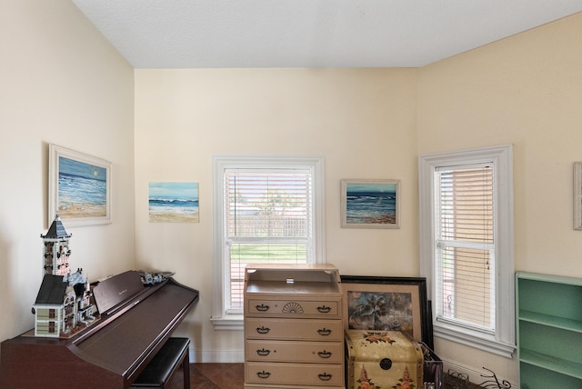 office area with a healthy amount of sunlight, tile patterned floors, and baseboards