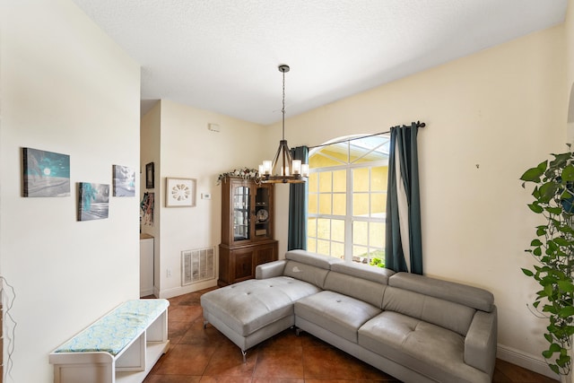interior space featuring a chandelier, visible vents, tile patterned flooring, and baseboards