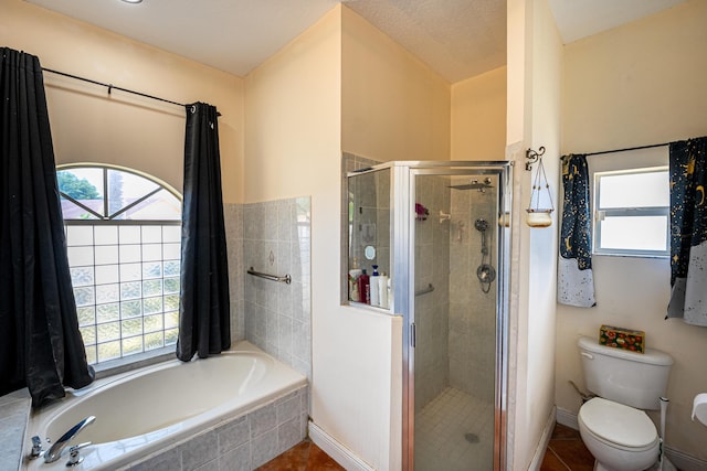 full bath with plenty of natural light, a garden tub, tile patterned floors, and a stall shower