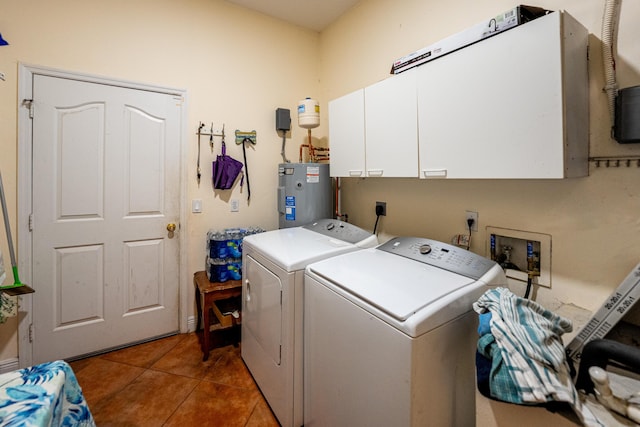 washroom featuring washer and clothes dryer, cabinet space, electric water heater, and tile patterned floors