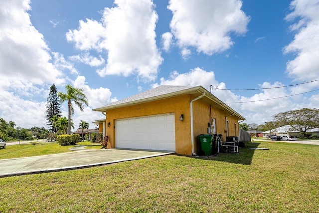 view of home's exterior with a yard, an attached garage, driveway, and stucco siding