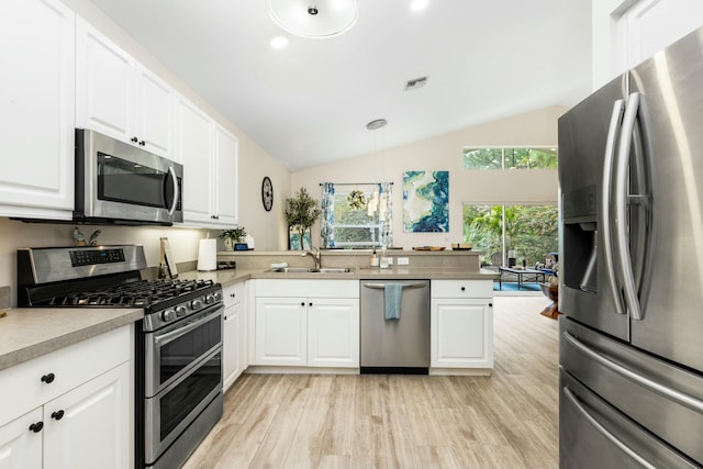 2394 SW Estella Ter, Palm City, FL 34990 - kitchen featuring a sink, white cabinets, visible vents, appliances with stainless steel finishes, and vaulted ceiling