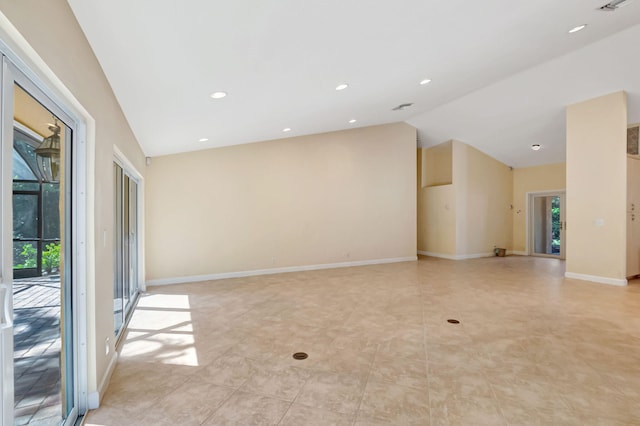 kitchen featuring lofted ceiling, stainless steel appliances, visible vents, light brown cabinetry, and beverage cooler