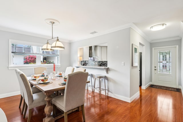 206 Lake Susan Ln, West Palm Beach, FL 33411 - dining space with crown molding, wood finished floors, and visible vents