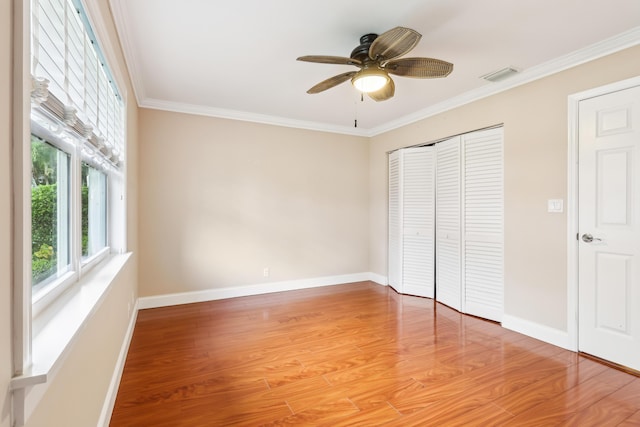 206 Lake Susan Ln, West Palm Beach, FL 33411 - unfurnished bedroom with light wood-type flooring, visible vents, a closet, and crown molding