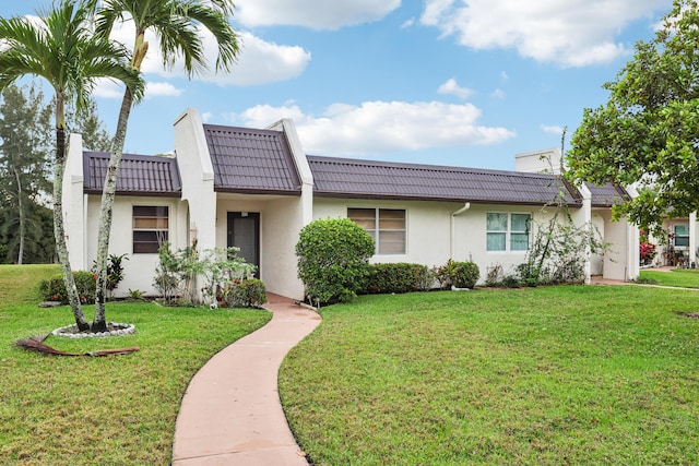 206 Lake Susan Ln, West Palm Beach, FL 33411 - view of front of house with a front yard, a tiled roof, and stucco siding