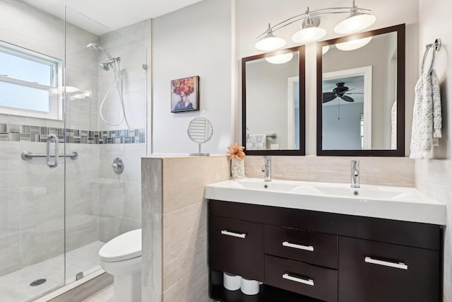 206 Lake Susan Ln, West Palm Beach, FL 33411 - full bath featuring a stall shower, tile walls, a ceiling fan, and double vanity