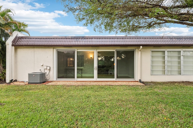 206 Lake Susan Ln, West Palm Beach, FL 33411 - back of house with a tile roof, a yard, central AC, and stucco siding