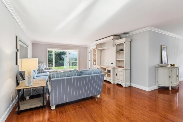 206 Lake Susan Ln, West Palm Beach, FL 33411 - living room featuring crown molding, wood finished floors, baseboards, and visible vents