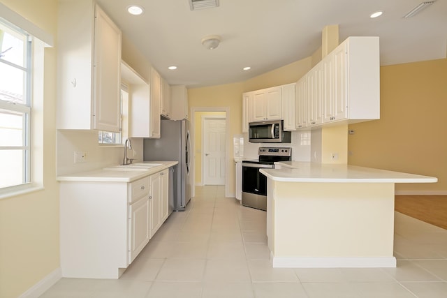 10828 SW Dardanelle Dr, Port Saint Lucie, FL 34987 - kitchen featuring a sink, recessed lighting, appliances with stainless steel finishes, a peninsula, and light countertops