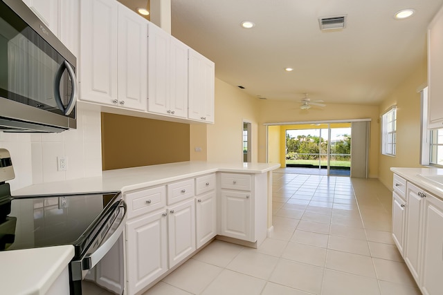 10828 SW Dardanelle Dr, Port Saint Lucie, FL 34987 - kitchen featuring tasteful backsplash, stainless steel microwave, visible vents, open floor plan, and electric range oven