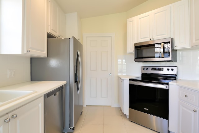 10828 SW Dardanelle Dr, Port Saint Lucie, FL 34987 - kitchen with white cabinets, light tile patterned floors, tasteful backsplash, and stainless steel appliances