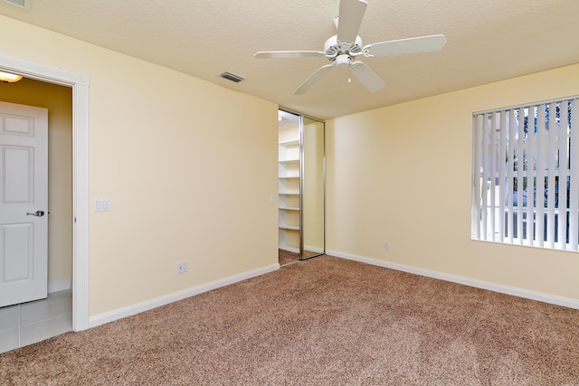 10828 SW Dardanelle Dr, Port Saint Lucie, FL 34987 - empty room with visible vents, baseboards, ceiling fan, carpet floors, and a textured ceiling