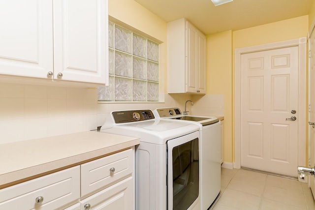 10828 SW Dardanelle Dr, Port Saint Lucie, FL 34987 - washroom with light tile patterned floors, cabinet space, and independent washer and dryer