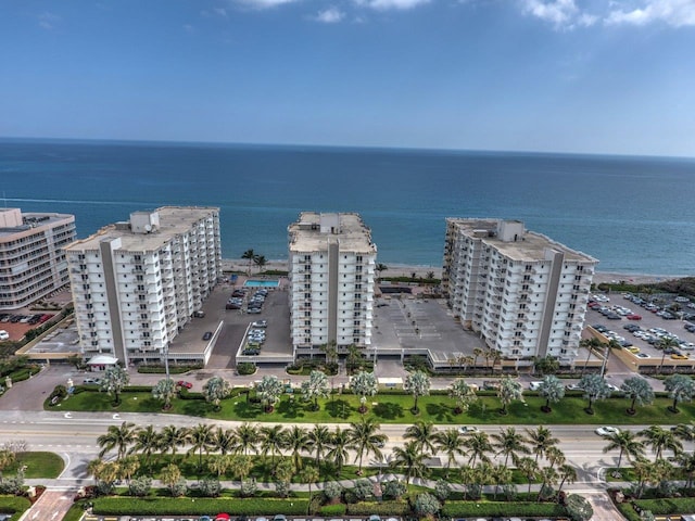 birds eye view of property featuring a view of city and a water view
