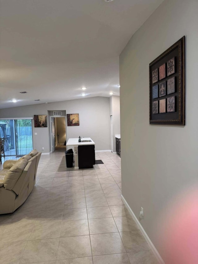 interior space with light tile patterned floors and baseboards