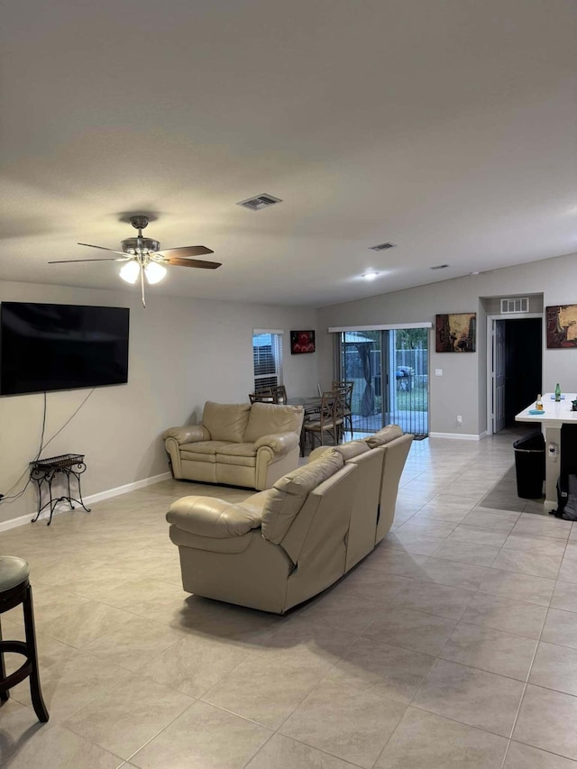 living area featuring visible vents, baseboards, and a ceiling fan