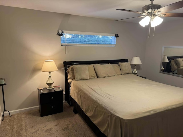 carpeted bedroom featuring baseboards and a ceiling fan