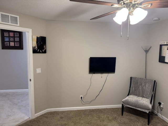 sitting room with carpet flooring, baseboards, a ceiling fan, and visible vents